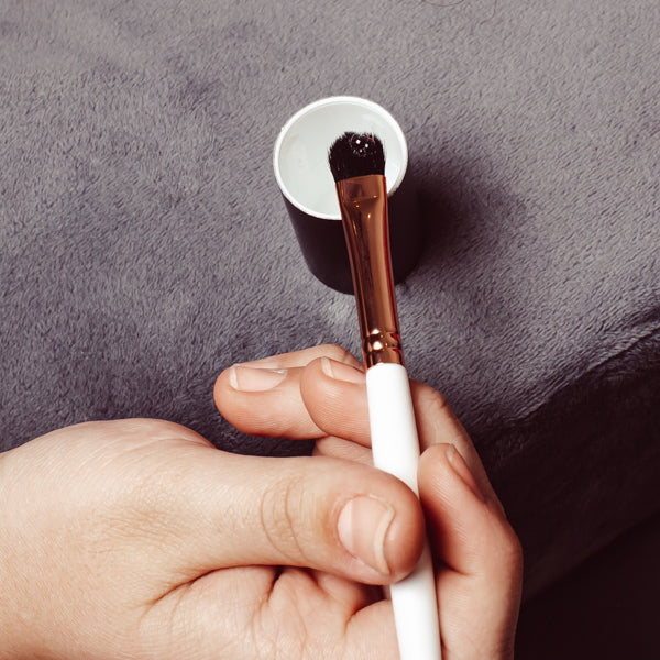Professional Eyelash Supplies, Lash Brush being dipped into Lash Primer